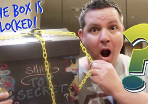 photo graphic of man gasping while holding a box that is locked with a yellow chain