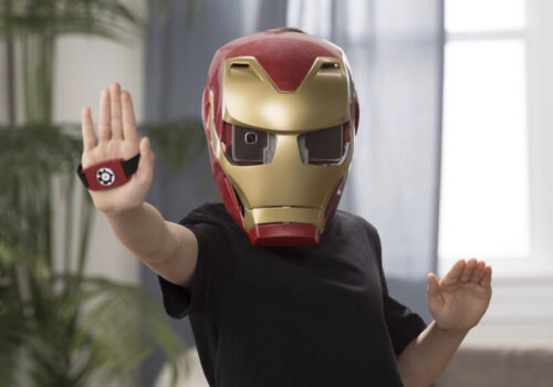 photo of child wearing iron man helmet and hand band