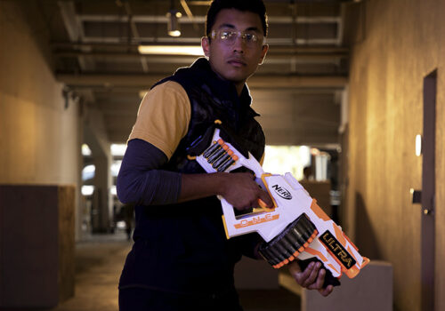 photo of a man holding a nerf ultra toy gun in a hallway